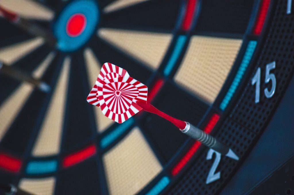A dart hitting a dartboard way off the bull's eye - analogy for completing tasks even though they're not 'perfect'
