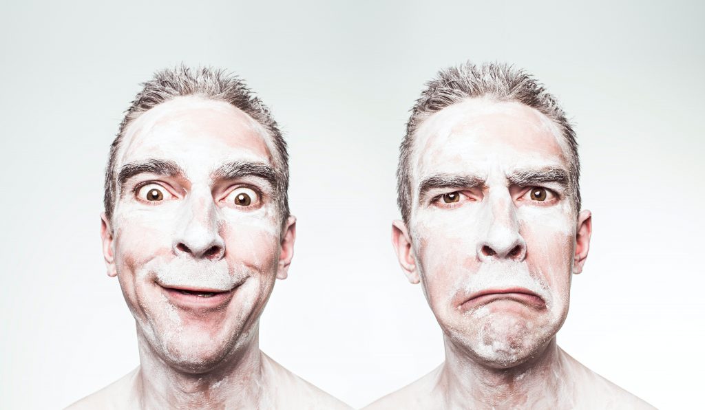 Man with flour all over his face, one picture of him looking happy, and the other looking sad. A caricature, almost. Like a mime. How your goal setting changes with your mood.