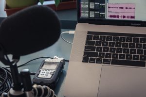 image of a podcast mic and a computer