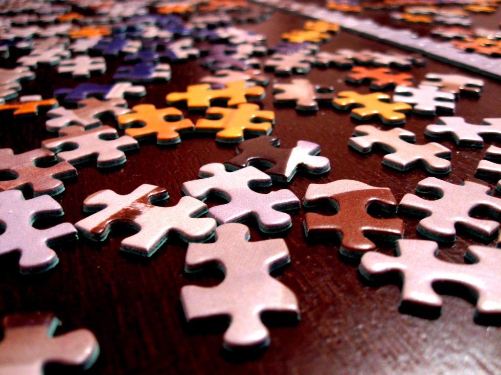 picture of a jigsaw with the pieces all scattered - when thinking about your to do list, think holistically, think of the whole picture