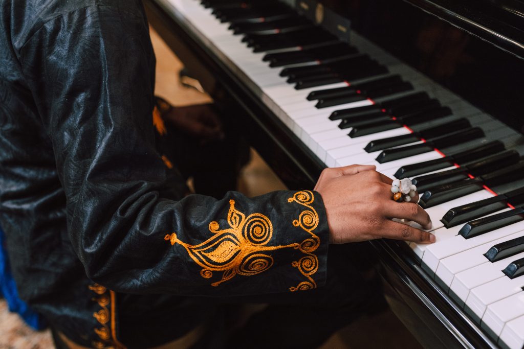 an image of a man playing piano, talking about doing what you love as an entrepreneur. starting a podcast should be in line with you holistically