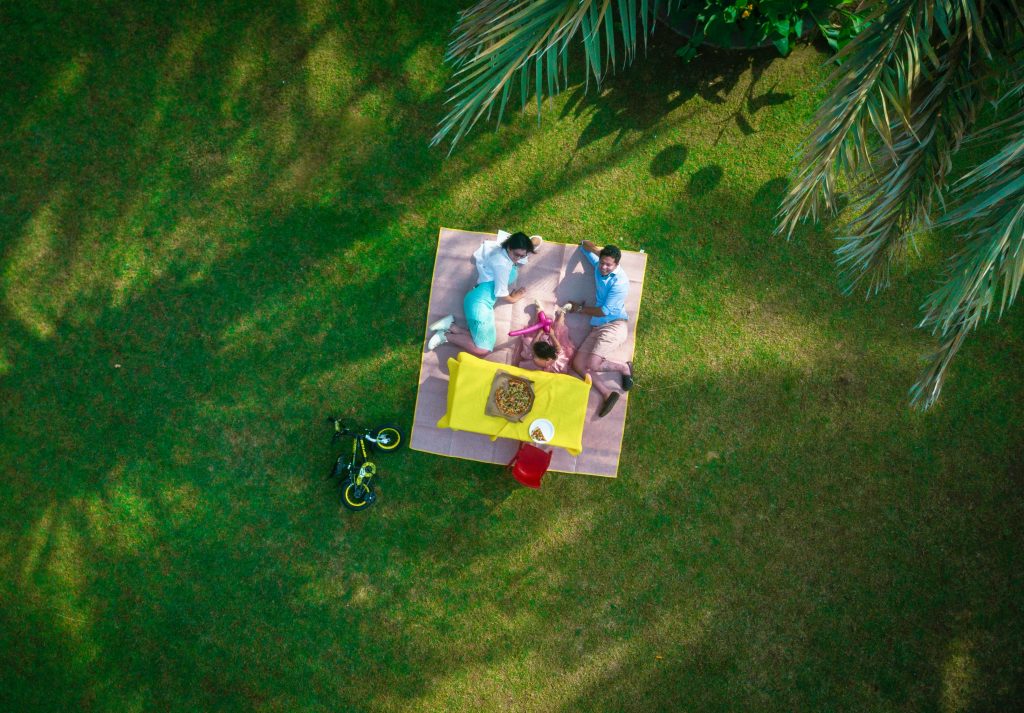picture of people relaxing on a mat, having a picnic. arial view. the importance of setting holistic goals as an entrepreneur