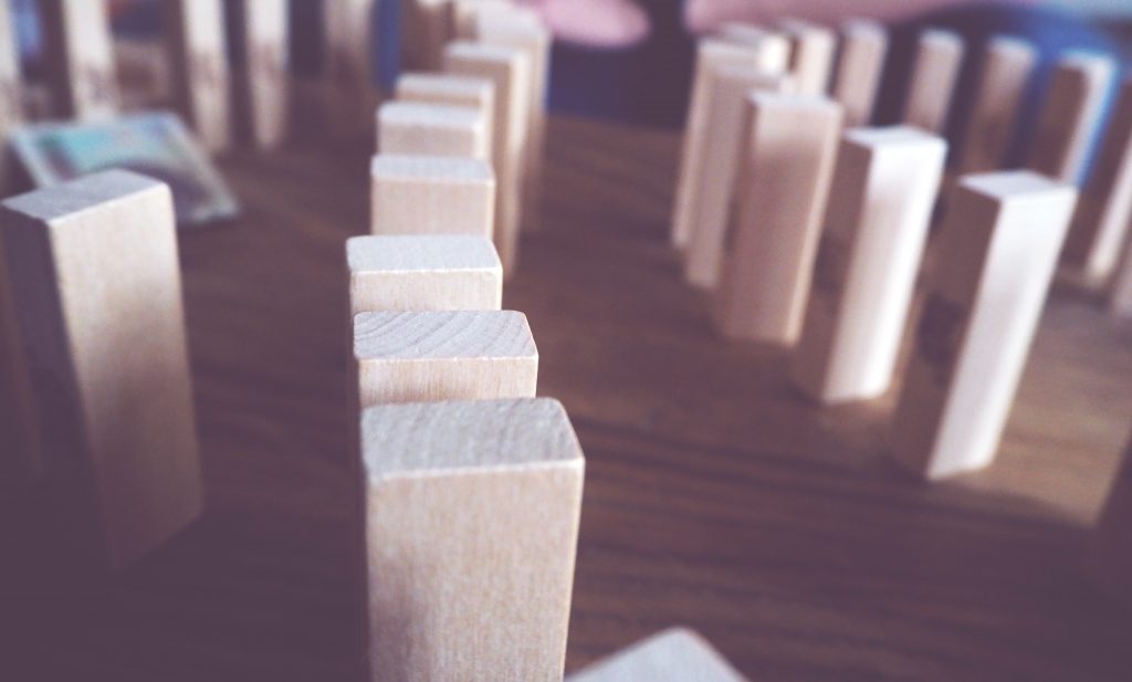 a picture of dominoes stood up ready to fall - representing compounding effect 
