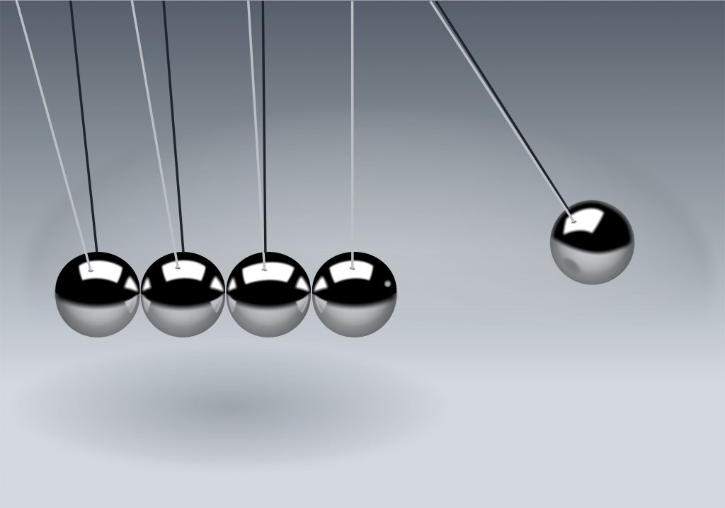 image of a newton's cradle representing repetition in business that will build growth slowly 