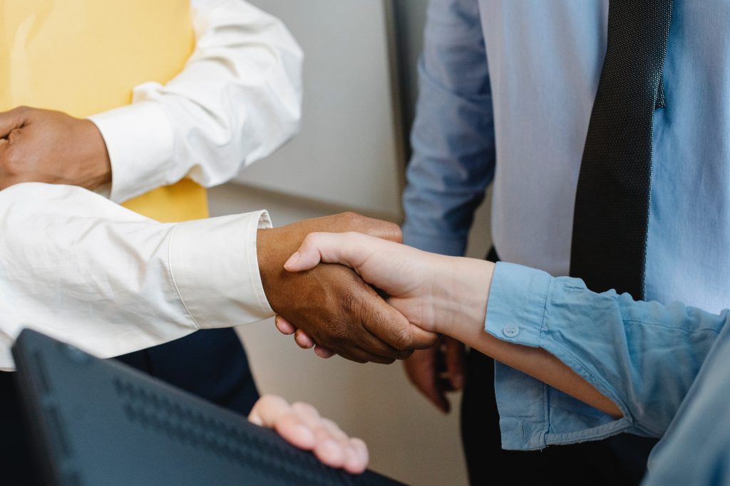 Two people shaking hands - symbolic of agreeing on selling a business