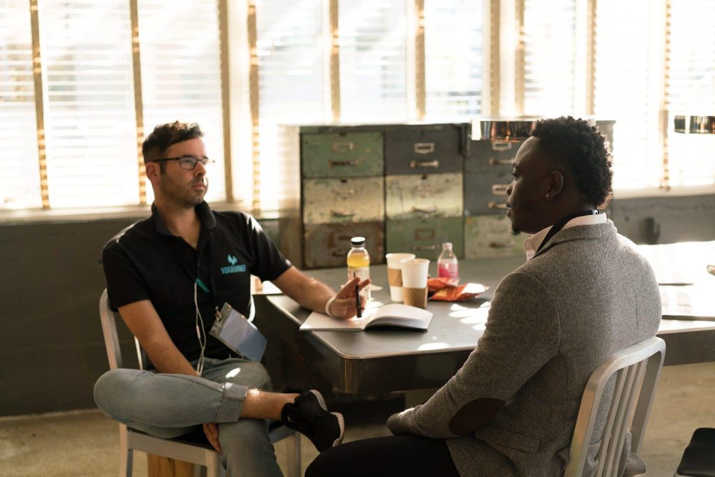 Entrepreneurs talking at office desk to make a decision