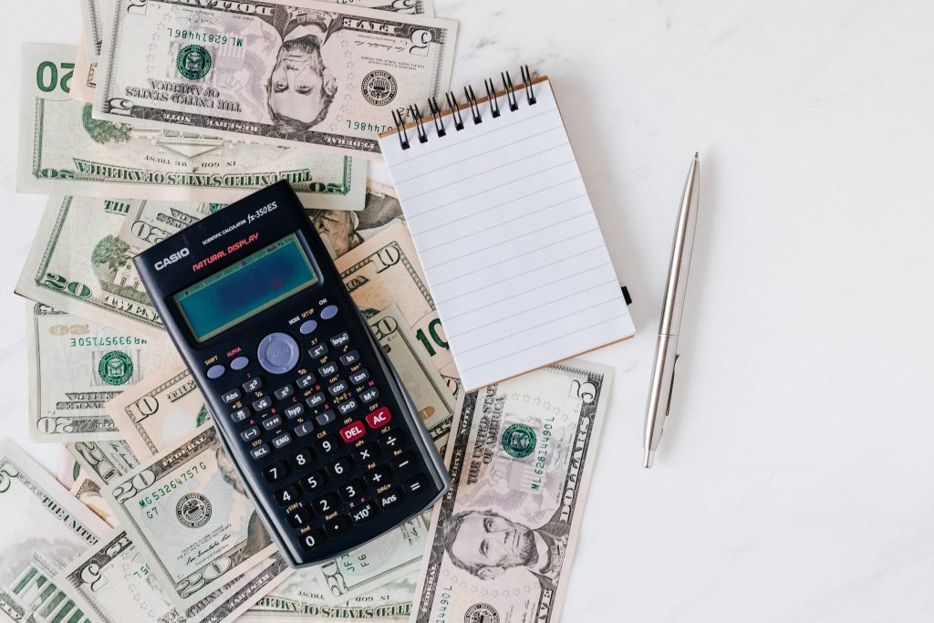 picture of calculator and money -financing for coaches
